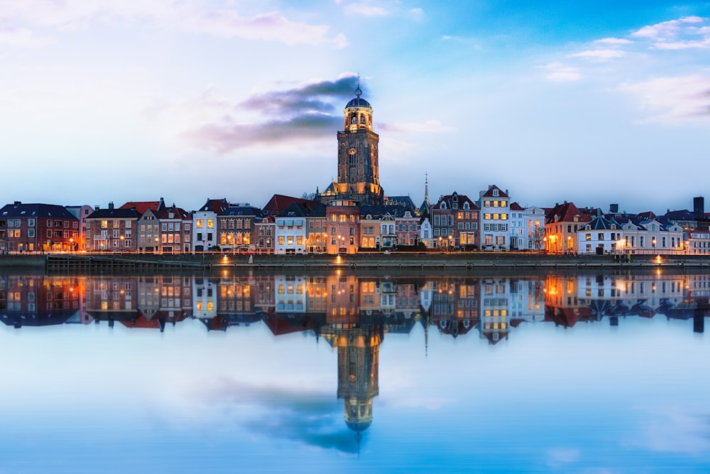 lighted buildings across placid lake