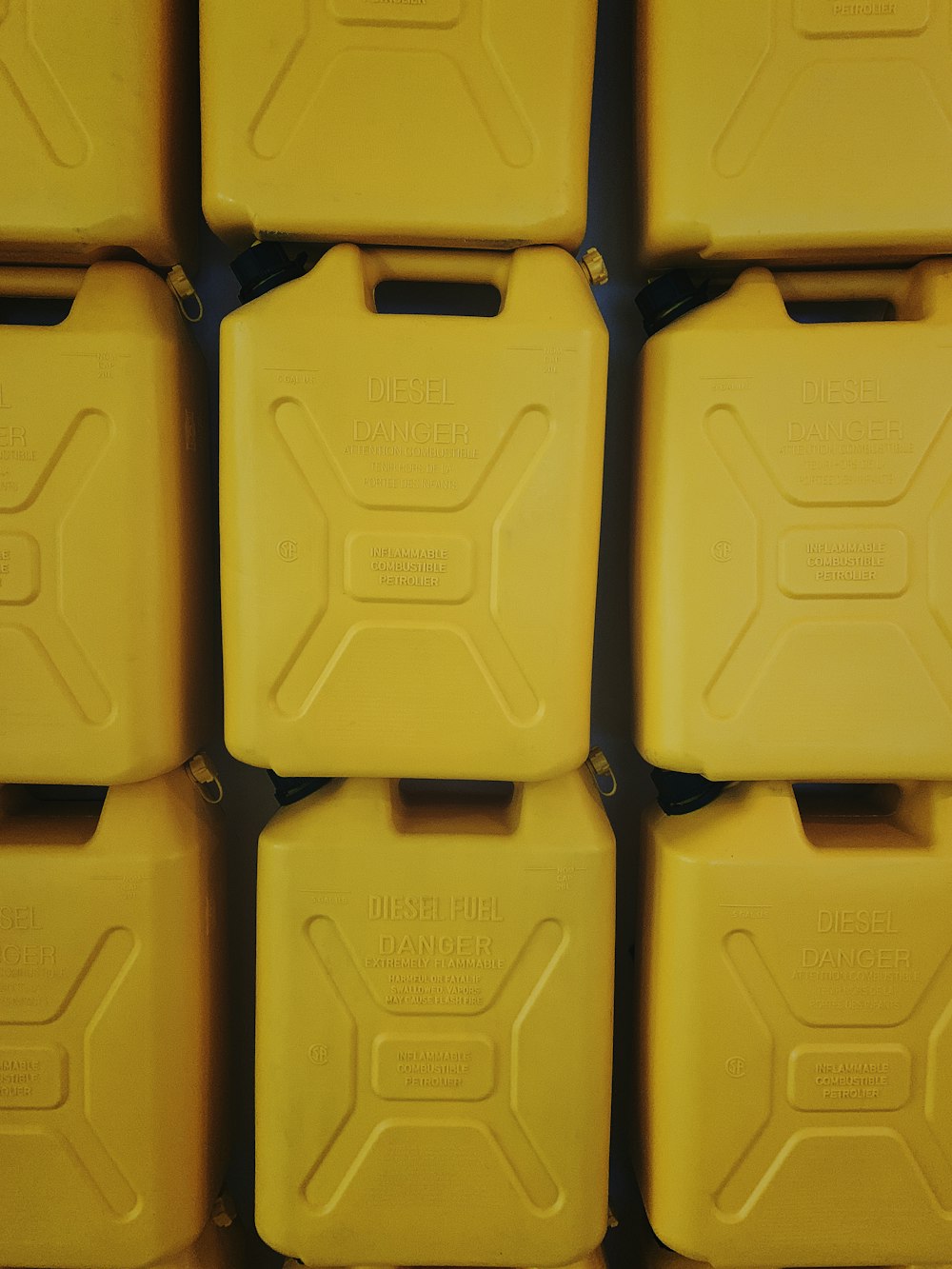 yellow plastic gallons close-up photography