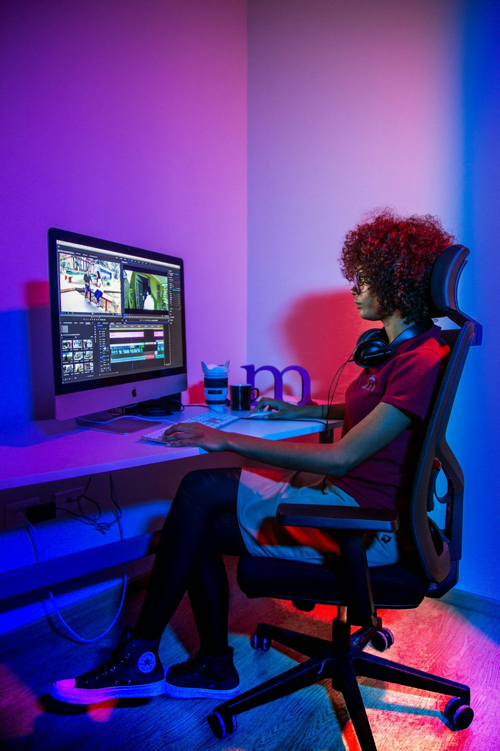 woman sits in front of open computer