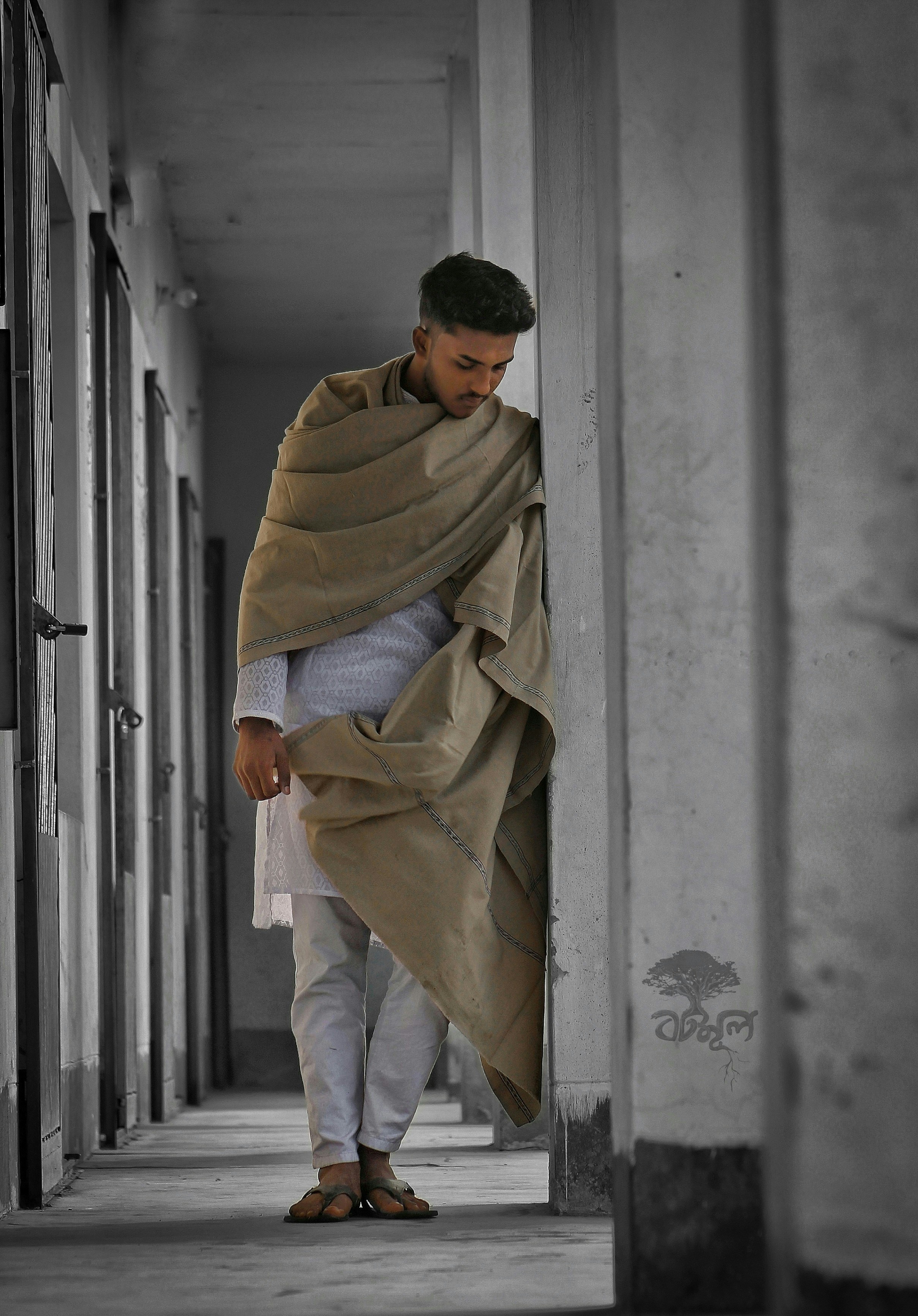 man in white thawb standing beside concrete pavement