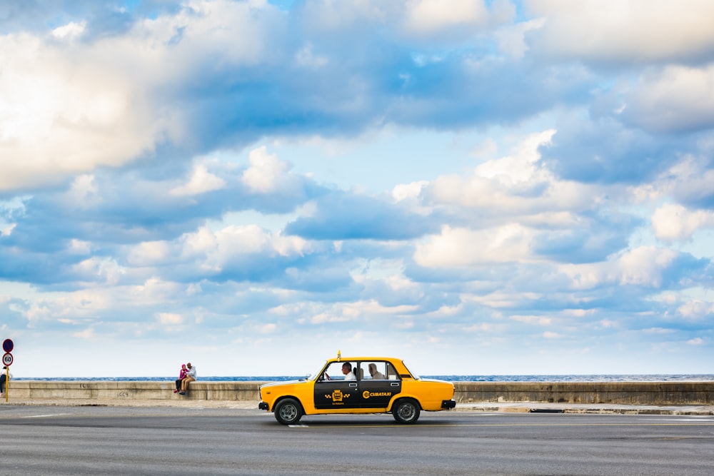 yellow and black car on beach during daytime
