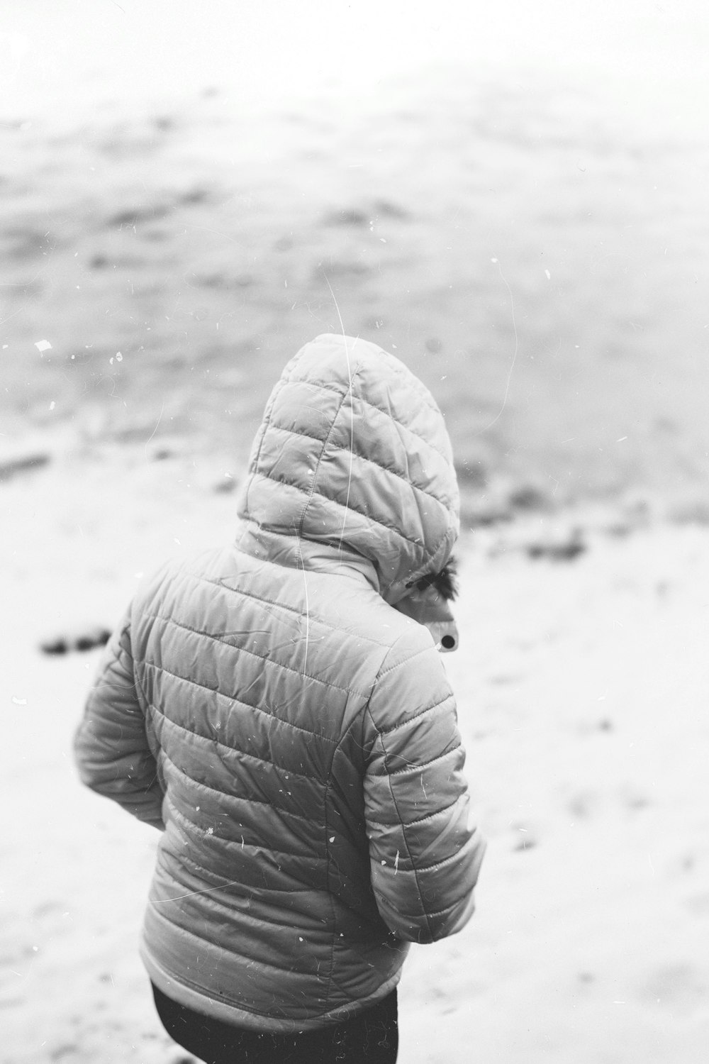 person wearing hooded bubble jacket