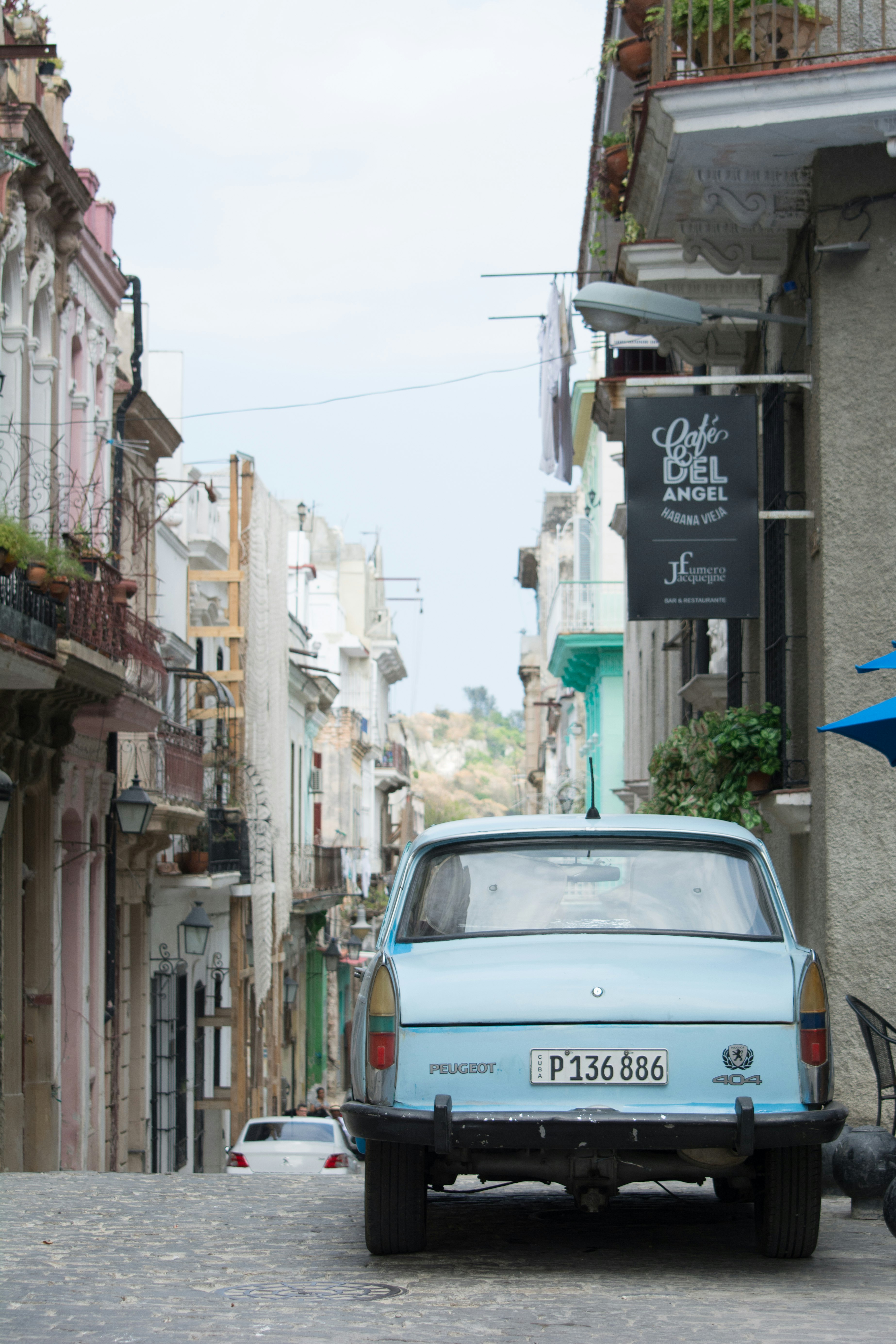 white car parked beside building during daytime