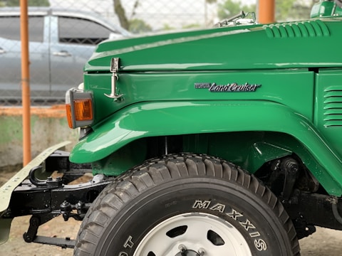 Before and after image of a Land Cruiser undergoing body repair and fresh paint.