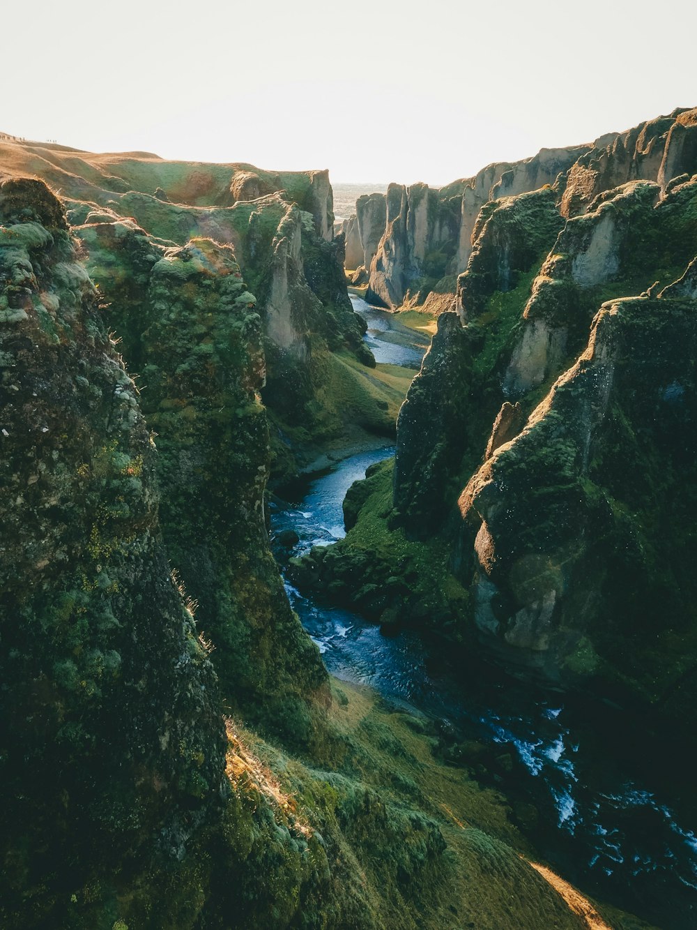 green cliffs near body of water