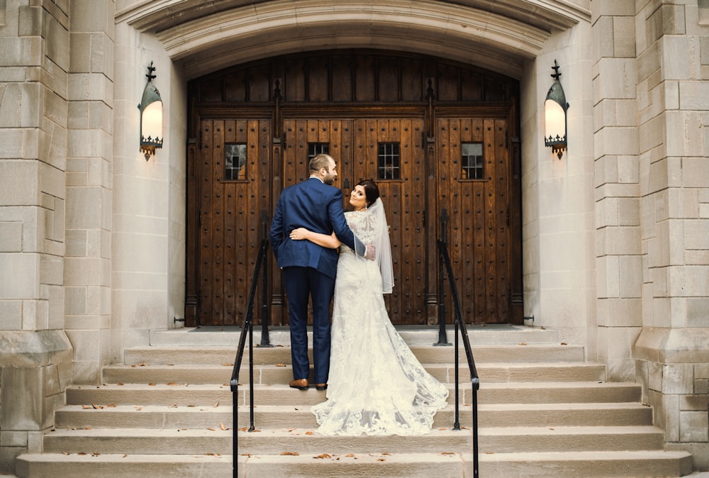groom and bride in front of door