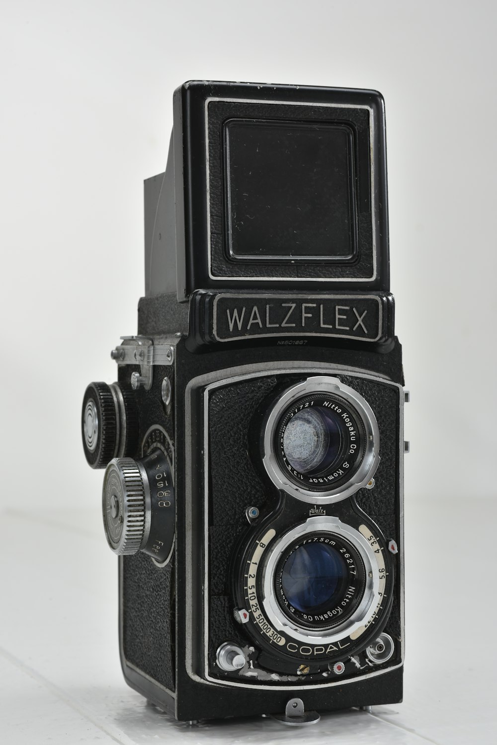 vintage black Walzflex camera on white surface