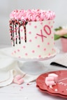white and pink coated fondant cake