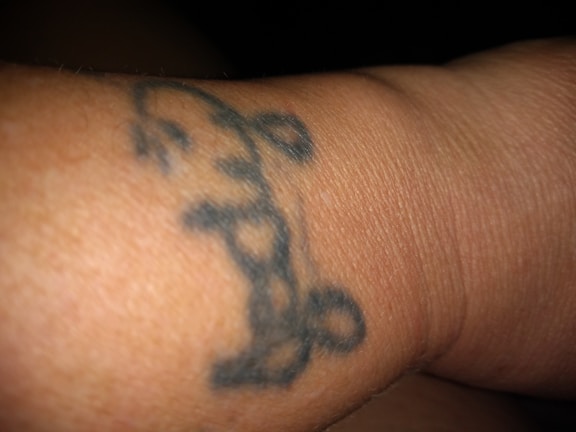 Front view of a black t-shirt with a gold crown graphic.