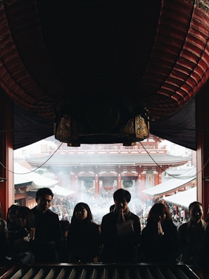 Devotees gathered in prayer under soft-focus lighting with bokeh effects.