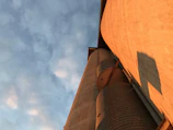 Stacked silos and pneumatic trailers at the Corpus Christi yard, bathed in golden afternoon light.