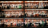 A vibrant display of assorted alcoholic beverages on a bar shelf.