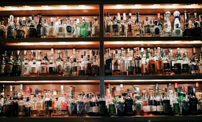 A vibrant display of assorted alcoholic beverages on a bar shelf.