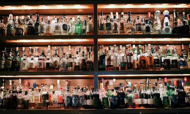 Shelves filled with an assortment of spirits and bottles behind the bar.