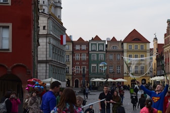 A smiling tour guide sharing stories with a small group in a vibrant city square