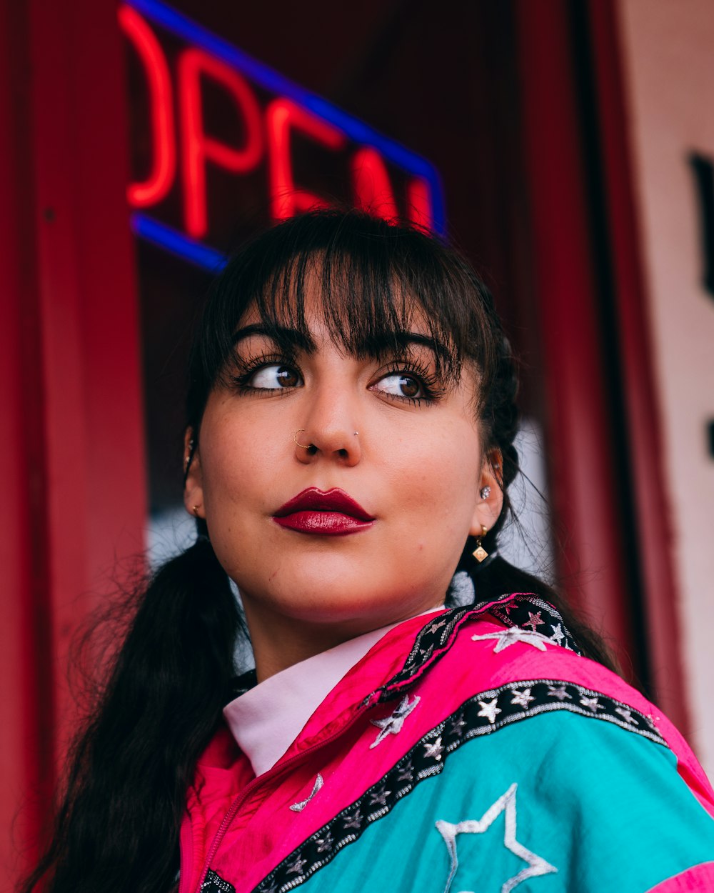 woman wearing pink and teal scarf looking someone