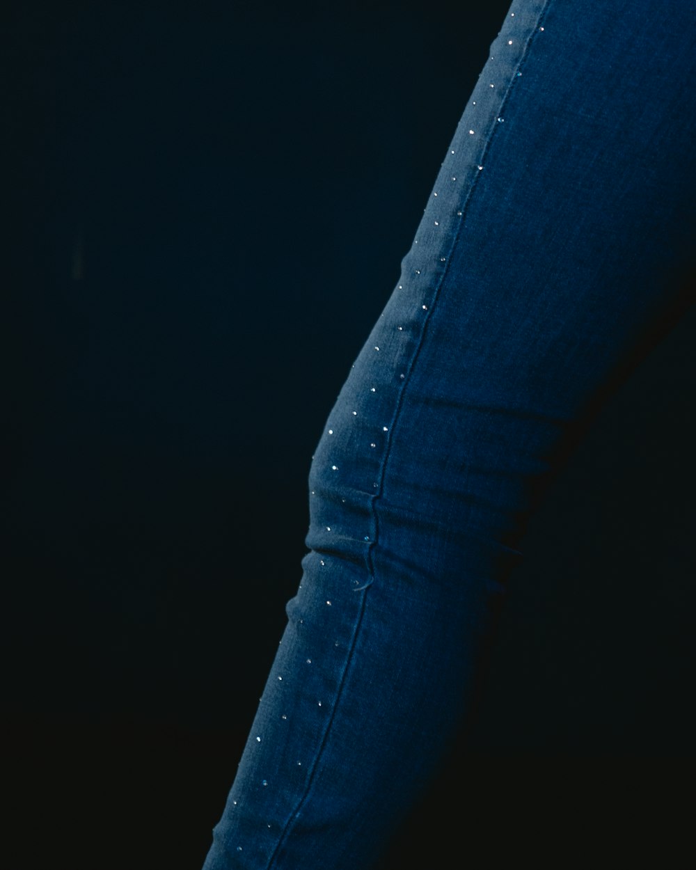 a close up of a person's legs wearing jeans
