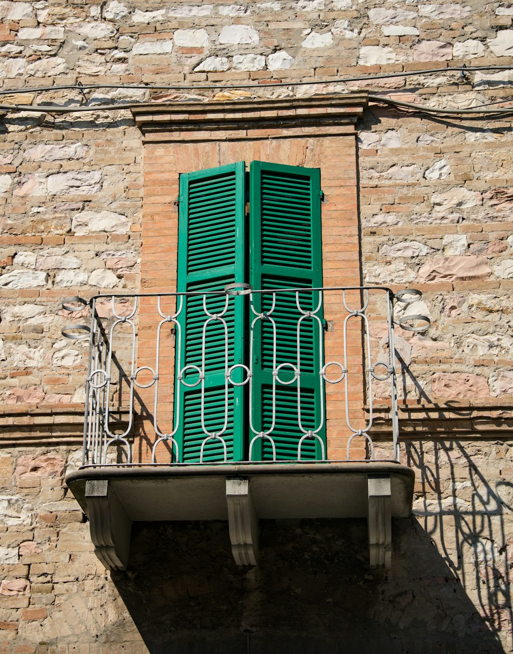 green balcony door near white steel rail