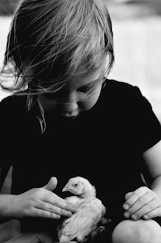 A happy family interacting lovingly with their newly adopted exotic bird at home.