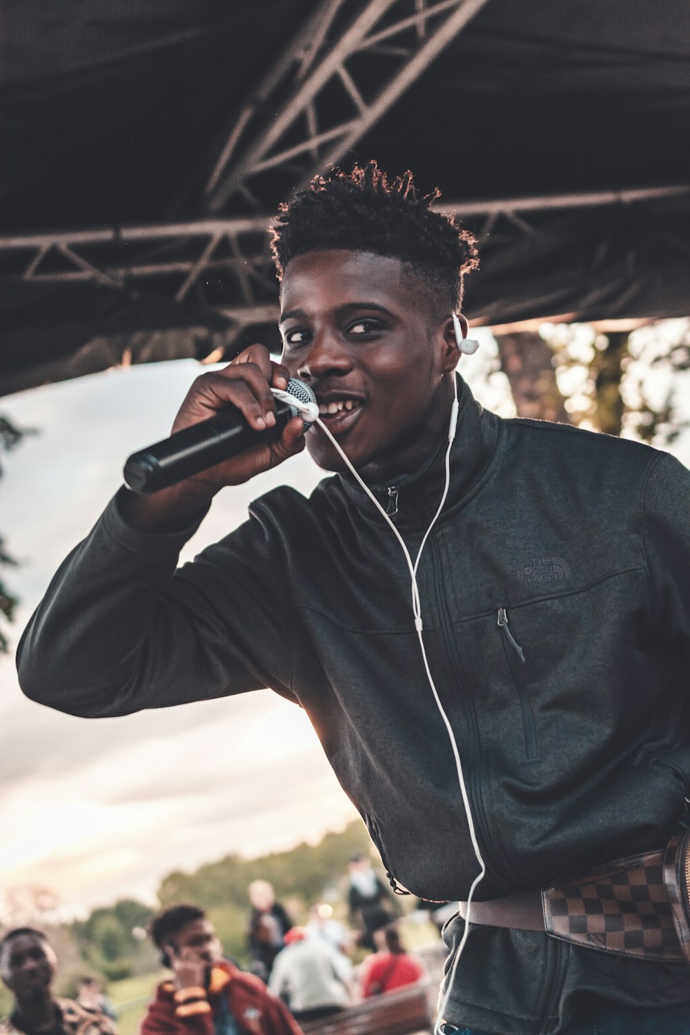 man holding black microphone performing on stage