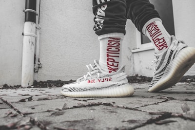 Sidewalk scene featuring sneakers and joggers from Rich Spirit’s latest drop.