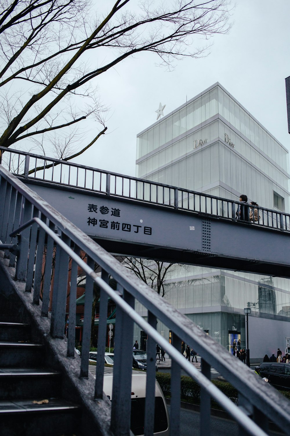 gray and white bridge near white concrete building during daytime