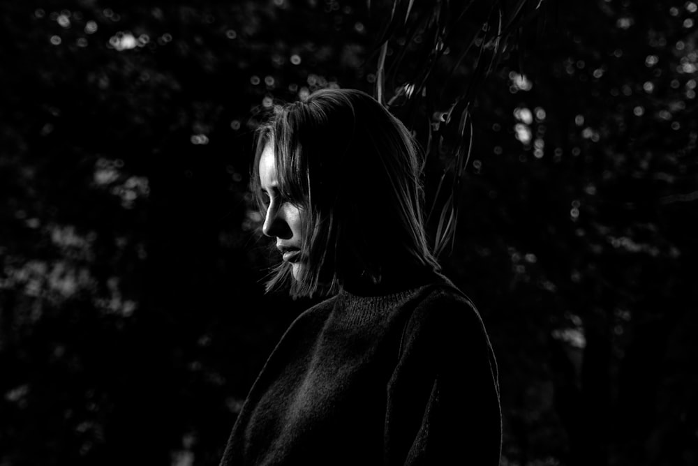 grayscale photo of woman in long-sleeved shirt