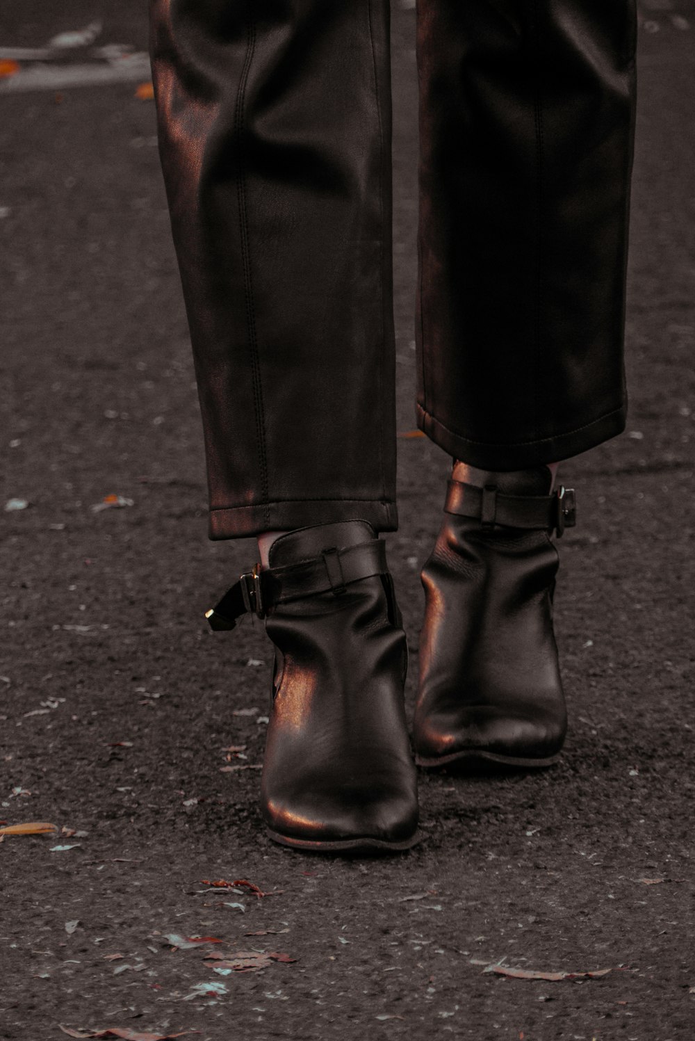 person wearing black leather boots
