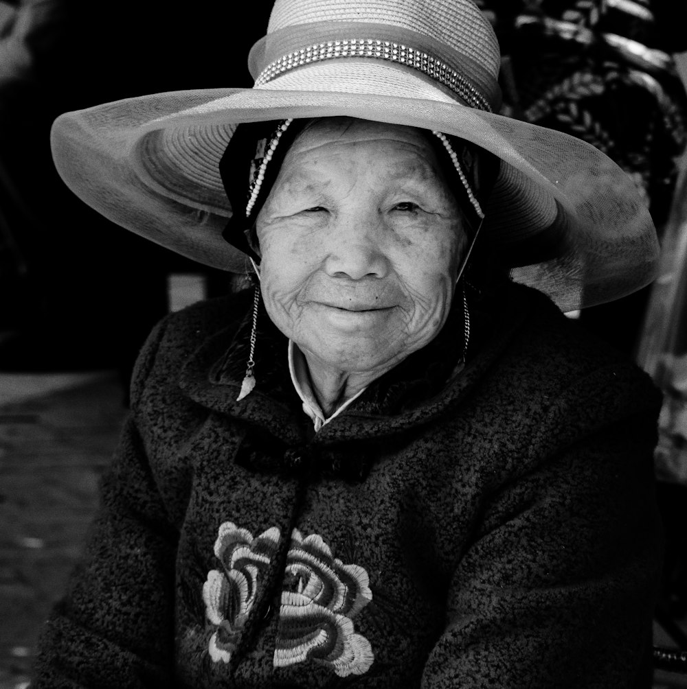 grayscale photo of woman wearing strawhat