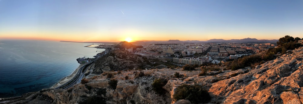 brown mountain range overlooking blue sea