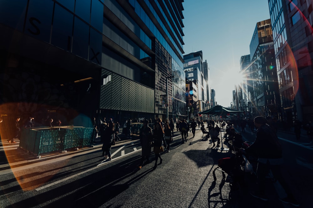 people walks between tall buildings