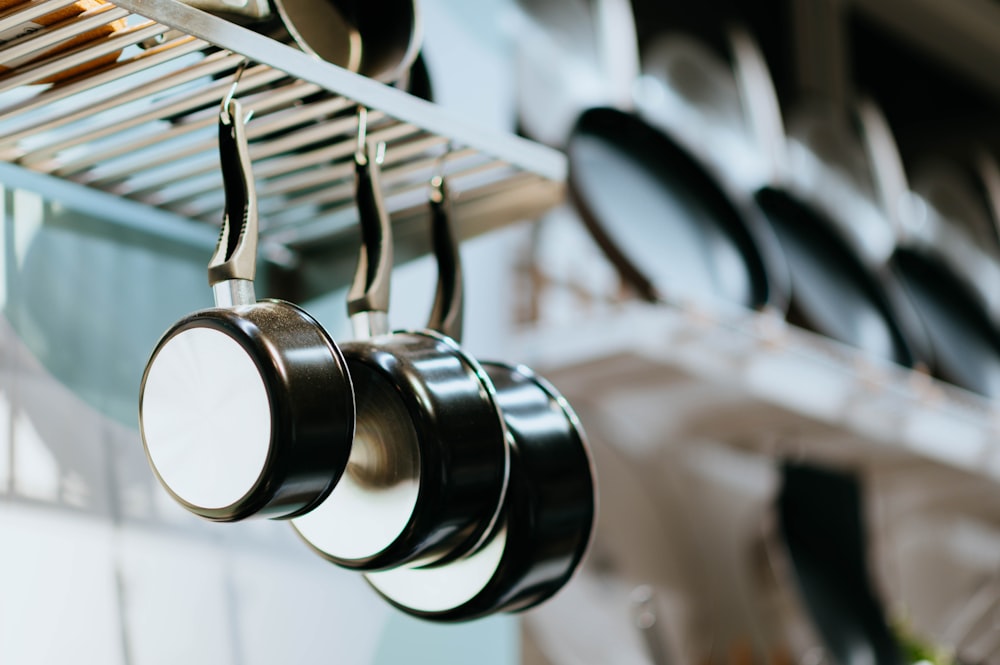 selective focus photography of three frying pans