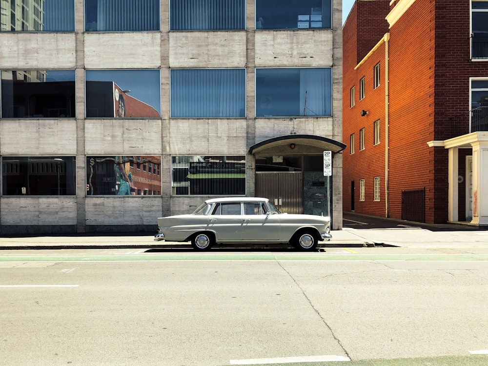 silver sedan on concrete road