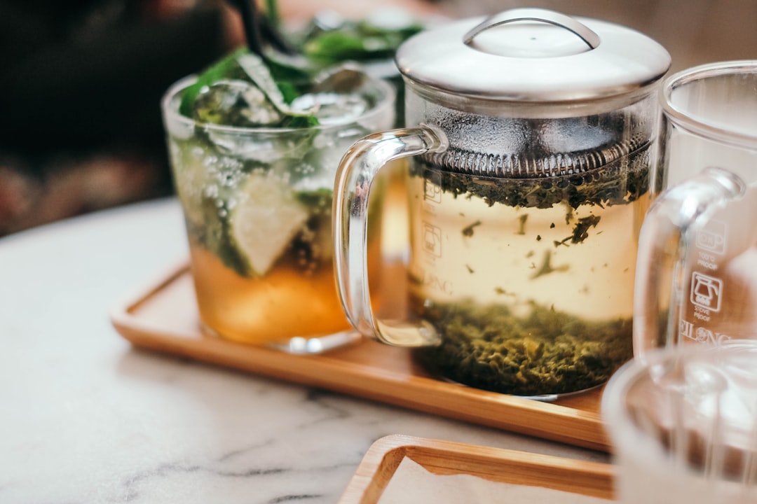 clear glass mug with green tea on tray