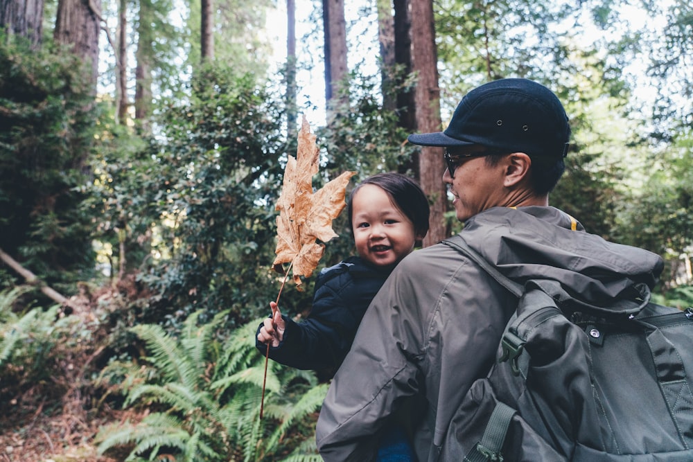 man carrying baby