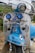 A vintage scooter with a predominantly blue and white color scheme, featuring various decorative elements including a small Italian flag decal, pin-up style artwork, and multiple chrome accessories. It has two blue auxiliary lights, a rearview mirror, and brand logos.