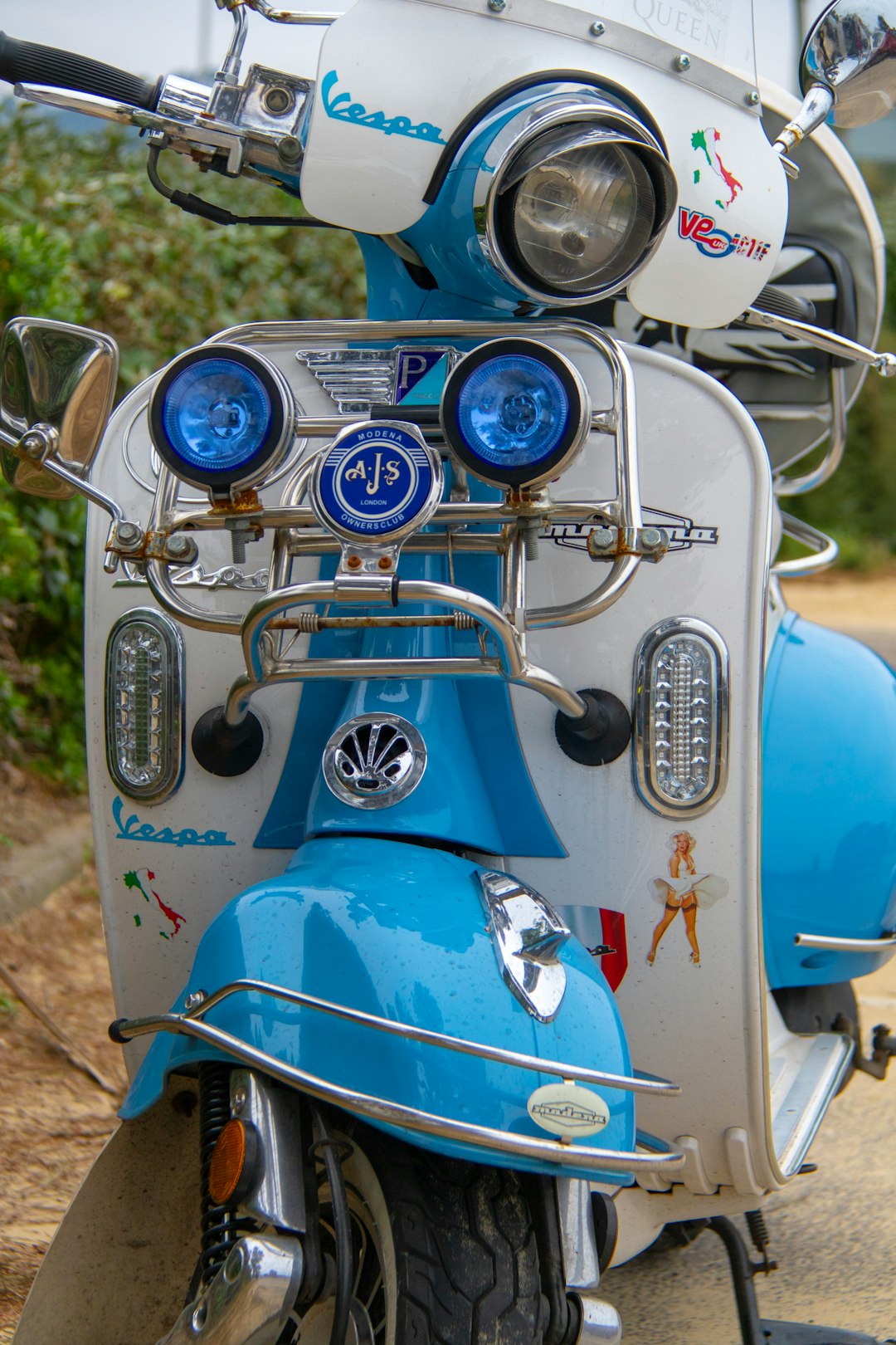 white and teal motor scooter