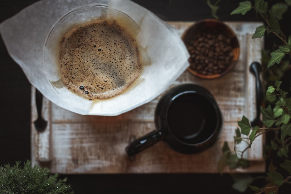 black ceramic mug and coffee beans