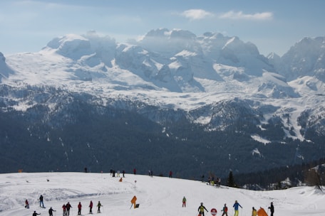 A group of diverse skiers training on a snowy slope.