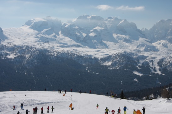 A joyful group of skiers training together on a snowy slope.