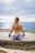 woman meditating front of sea at daytime