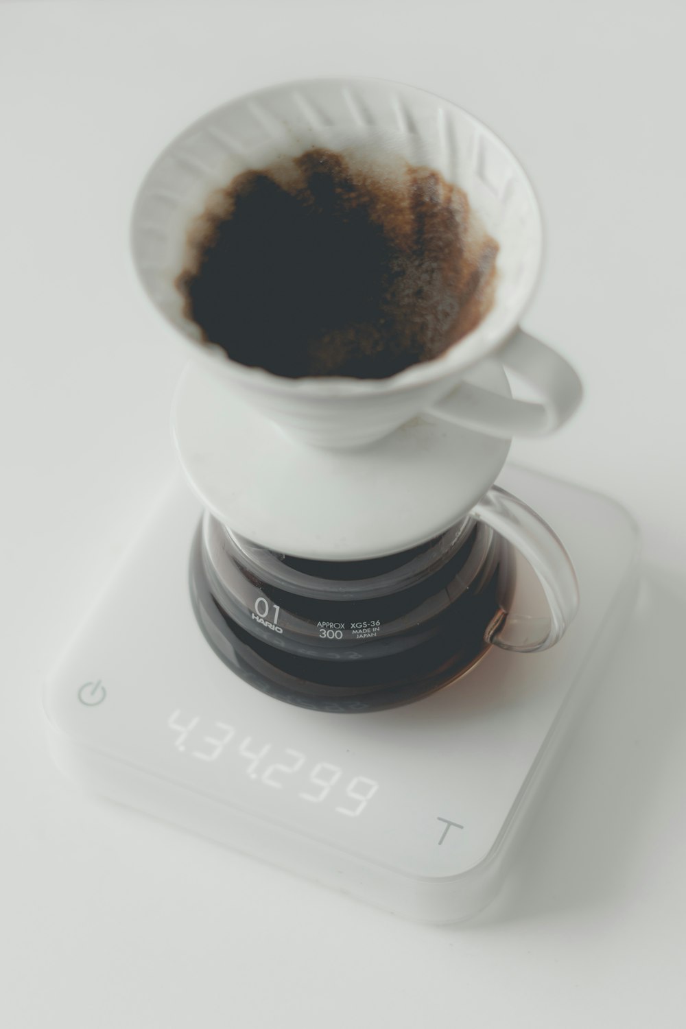 white ceramic mug and clear glass container