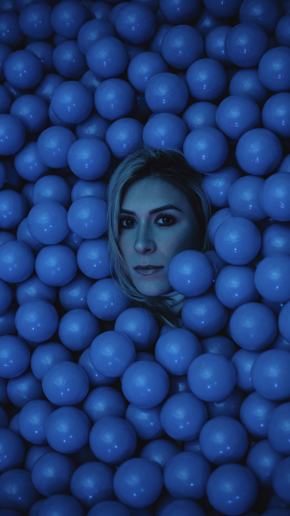 woman's face surrounded by blue balls