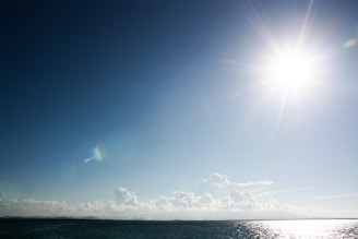 A bright sun symbolizing clarity shining over a calm sea.