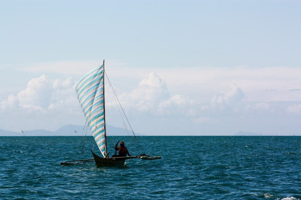 person sailing surrounded by body of water