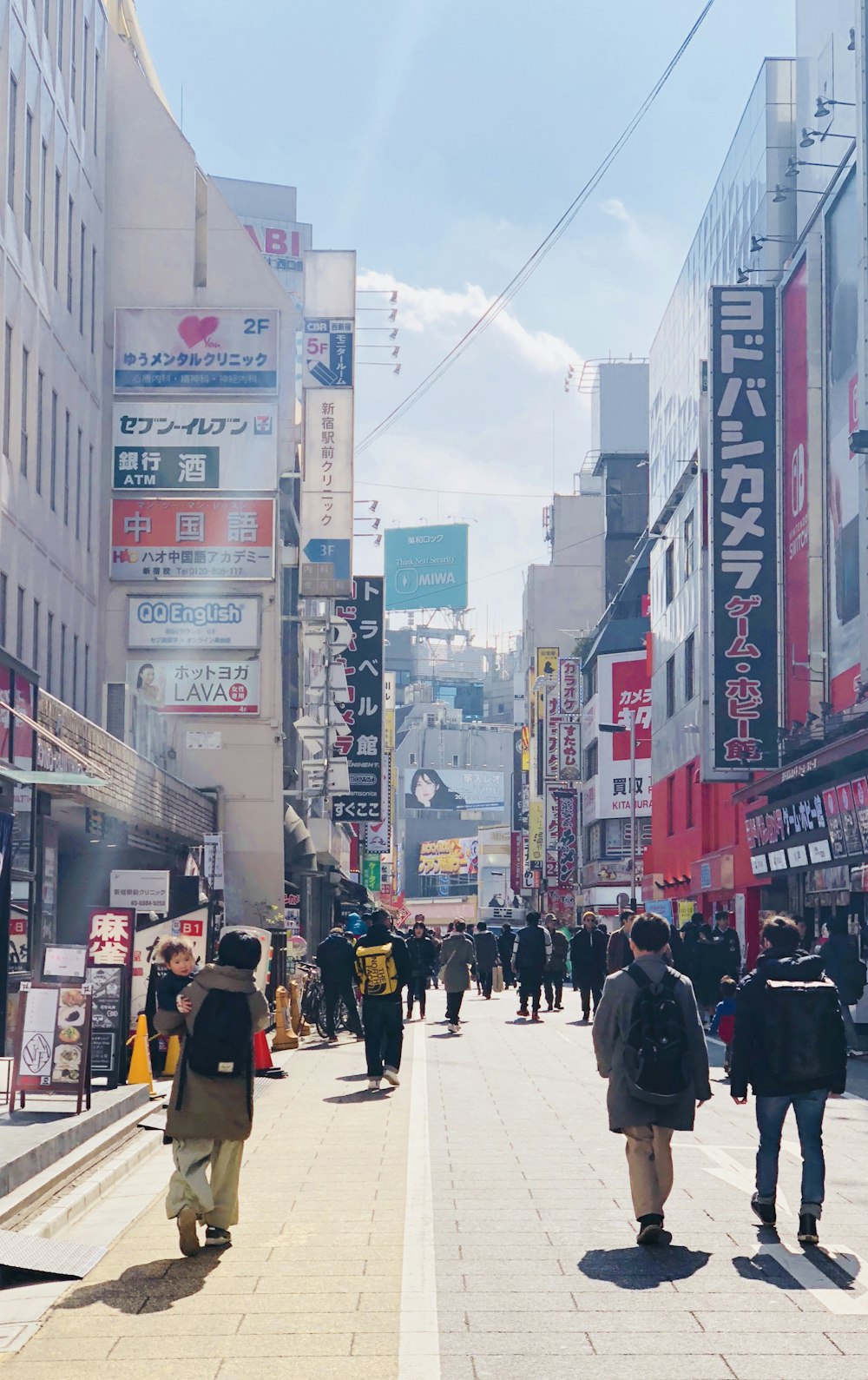 people walking on street in between building during daytime