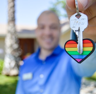 selective photo of gray key with heart key chain