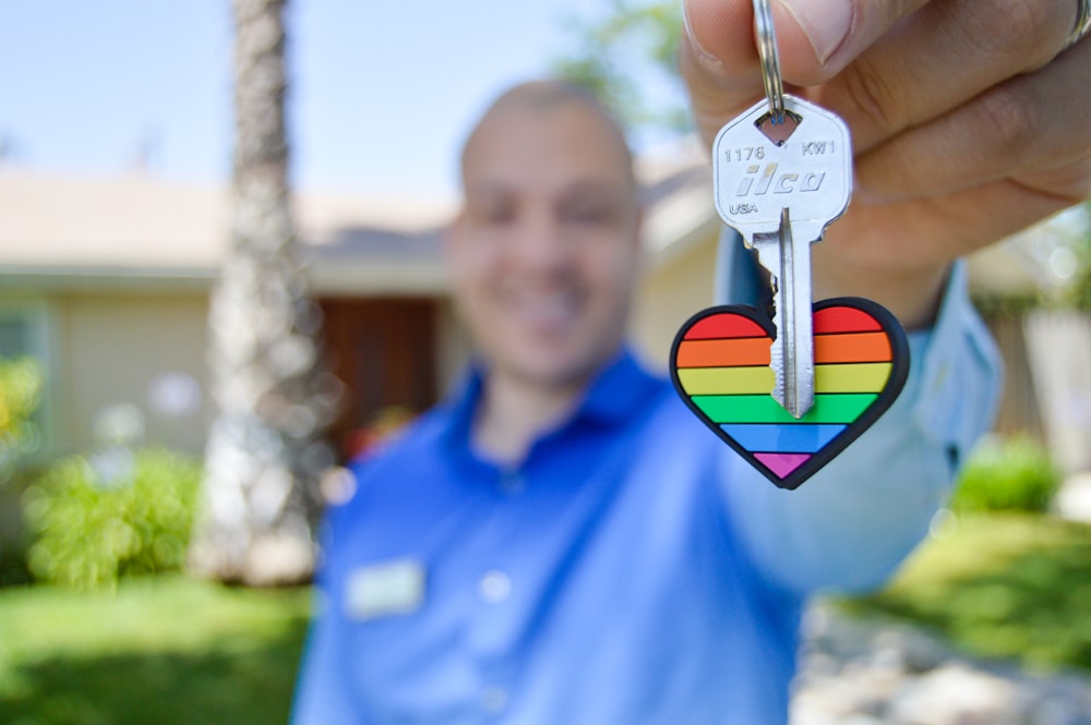 selective photo of gray key with heart key chain