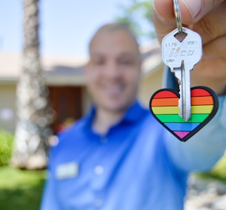 selective photo of gray key with heart key chain