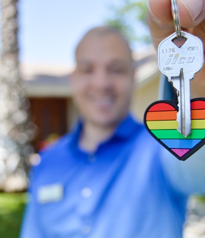 selective photo of gray key with heart key chain